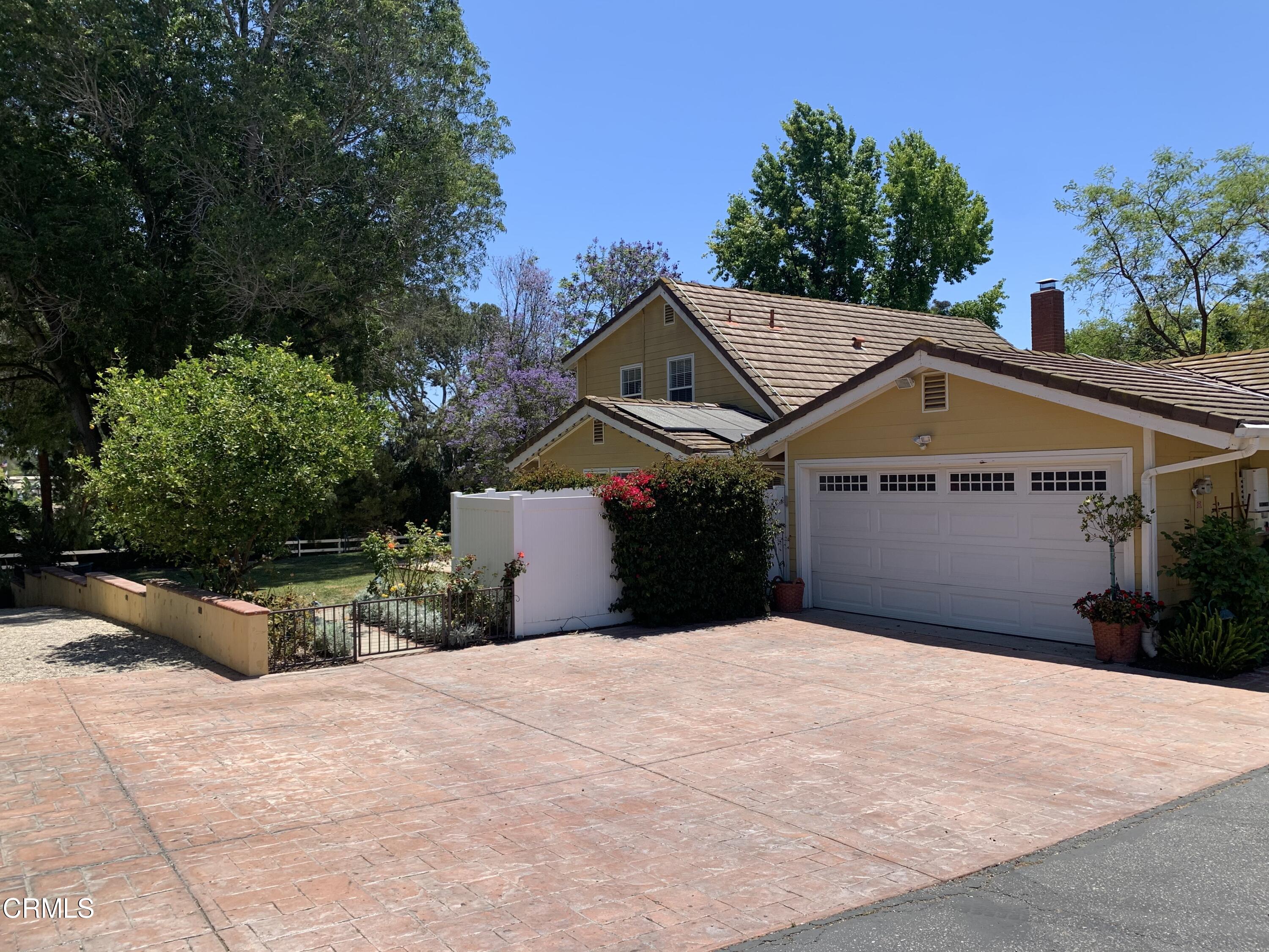 6009 La Cumbre Road Somis, CA 93066 - Photo 3 of 29 a front view of a house with a yard and garage