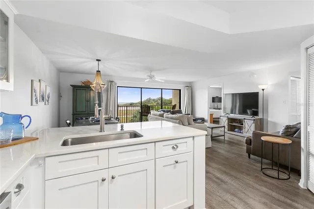 a view of living room kitchen with furniture and wooden floor