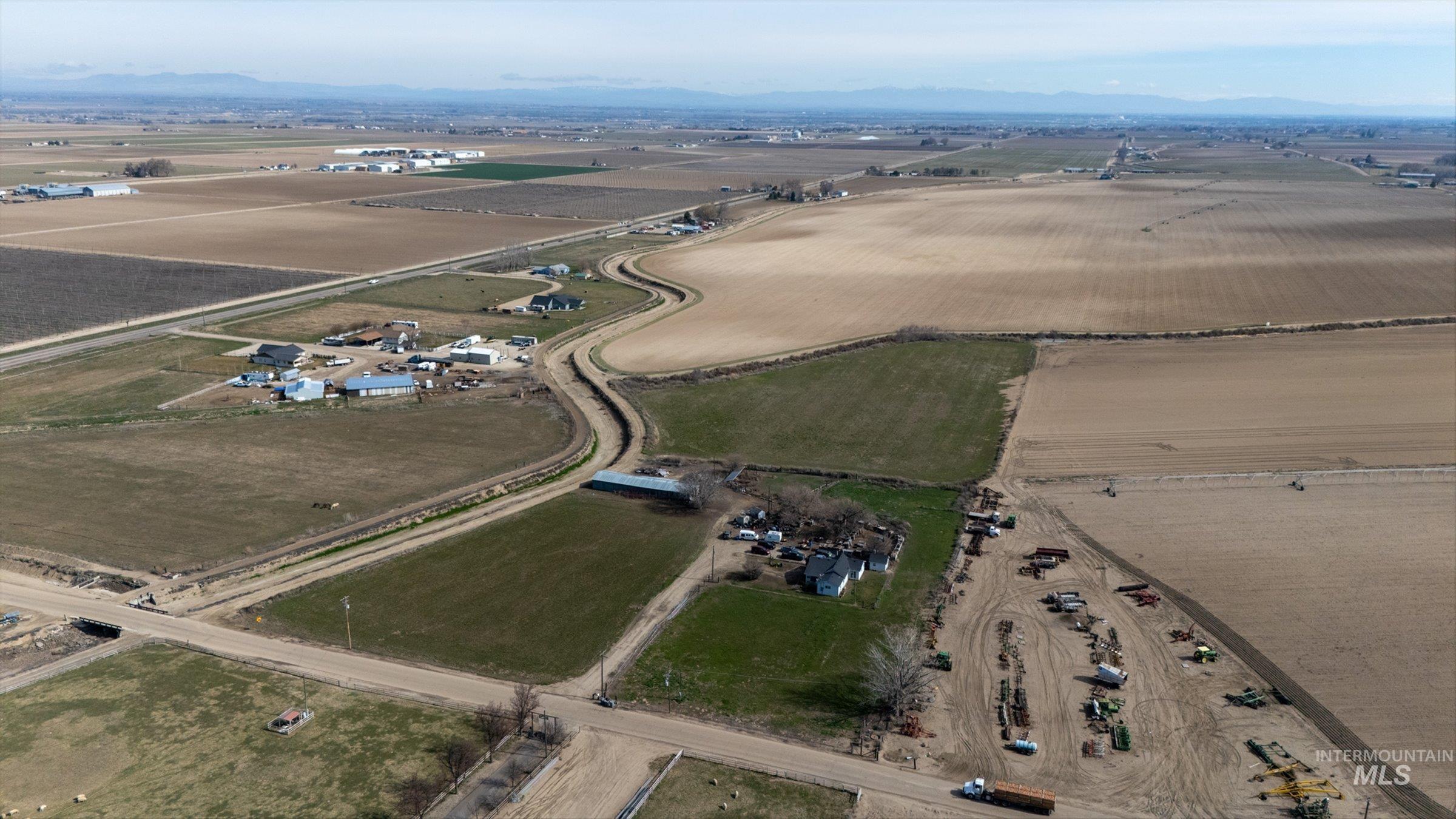20286 Travis Road Wilder, ID 83676 - Photo 17 of 27 Aerial view of property's location featuring rural landscape, mountains, and abundant farmland