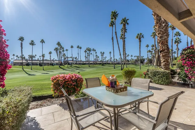 a view of a chairs and table in patio with a lake view