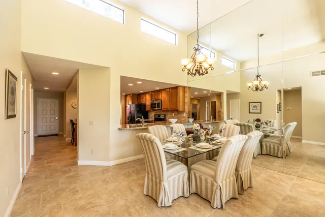 a bedroom with a large bed and a flat tv screen on dresser