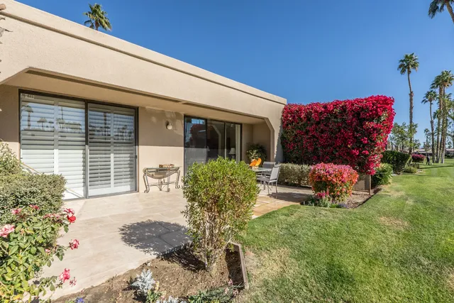 a living room with furniture windows and a chandelier