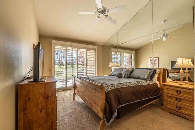 a bathroom with a granite countertop sink a toilet and a mirror