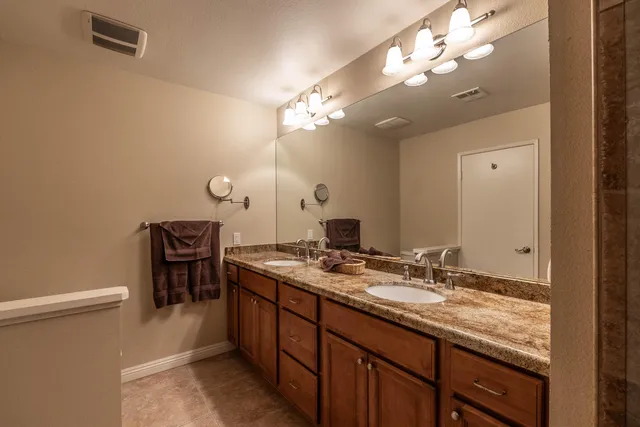 a bathroom with a shower sink and mirror