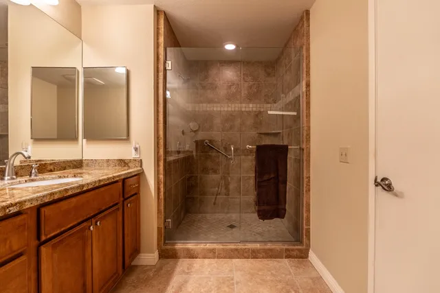 a bedroom with a large bed and a chandelier