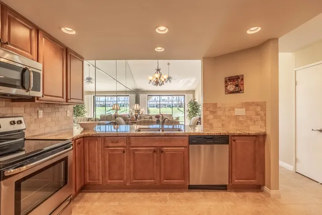 a living room with lots of furniture and a chandelier