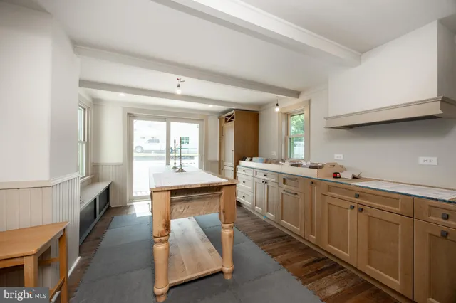 a large bathroom with a double vanity sink a mirror and a bathtub