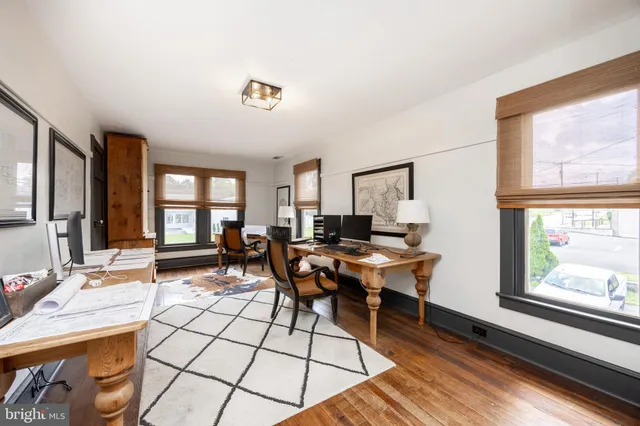 a view of a workspace with furniture and a window