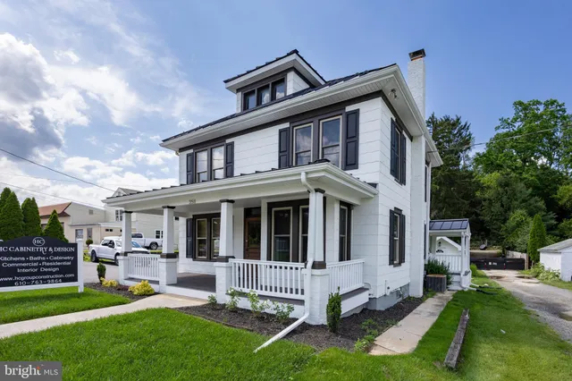 a front view of a house with a yard table and chairs
