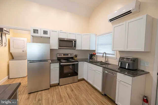 a kitchen with cabinets stainless steel appliances and a counter space