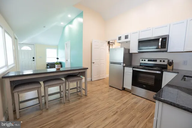 a kitchen with stainless steel appliances a stove a sink and a refrigerator