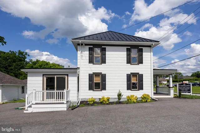a front view of a house with a garden