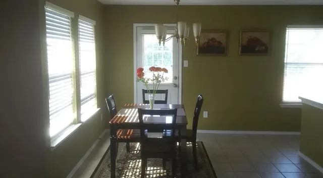 a view of a dining room with furniture and window