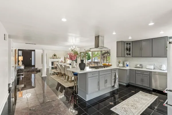 a kitchen with sink cabinets and stove top oven