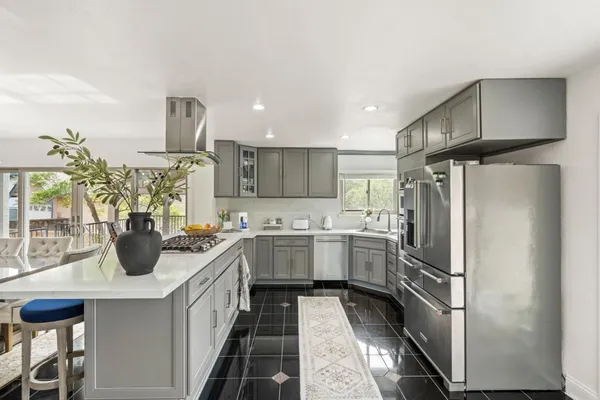 a kitchen with a sink appliances and cabinets