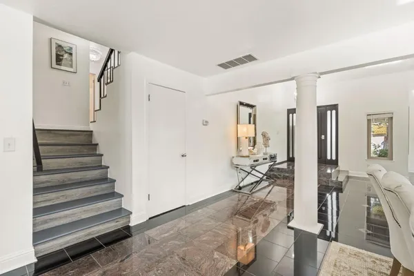 a very nice looking room with wooden floor and stairs
