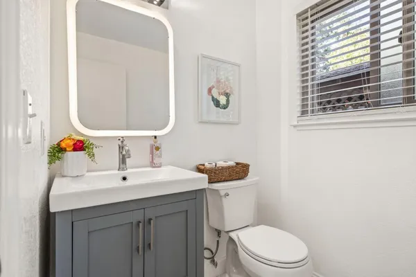 a bathroom with a toilet sink and mirror