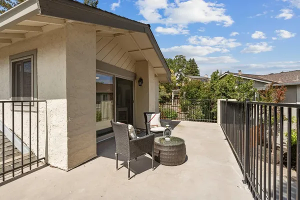 a view of a chairs and deck in the back yard