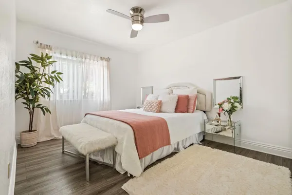 a bedroom with a bed and a night stand