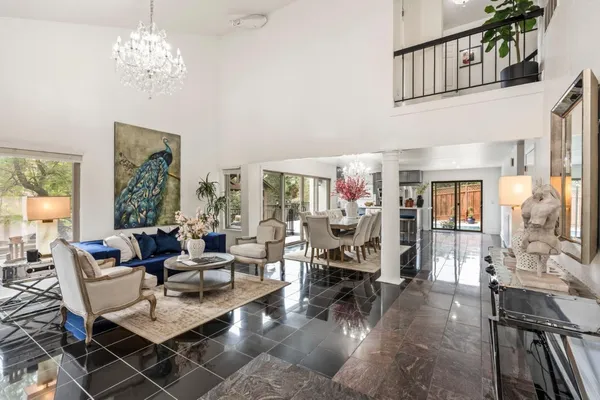 a living room with fireplace furniture and a chandelier