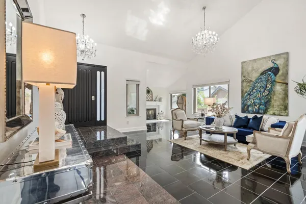a living room with fireplace furniture and a flat screen tv