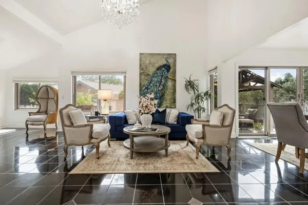 a living room with furniture and a chandelier