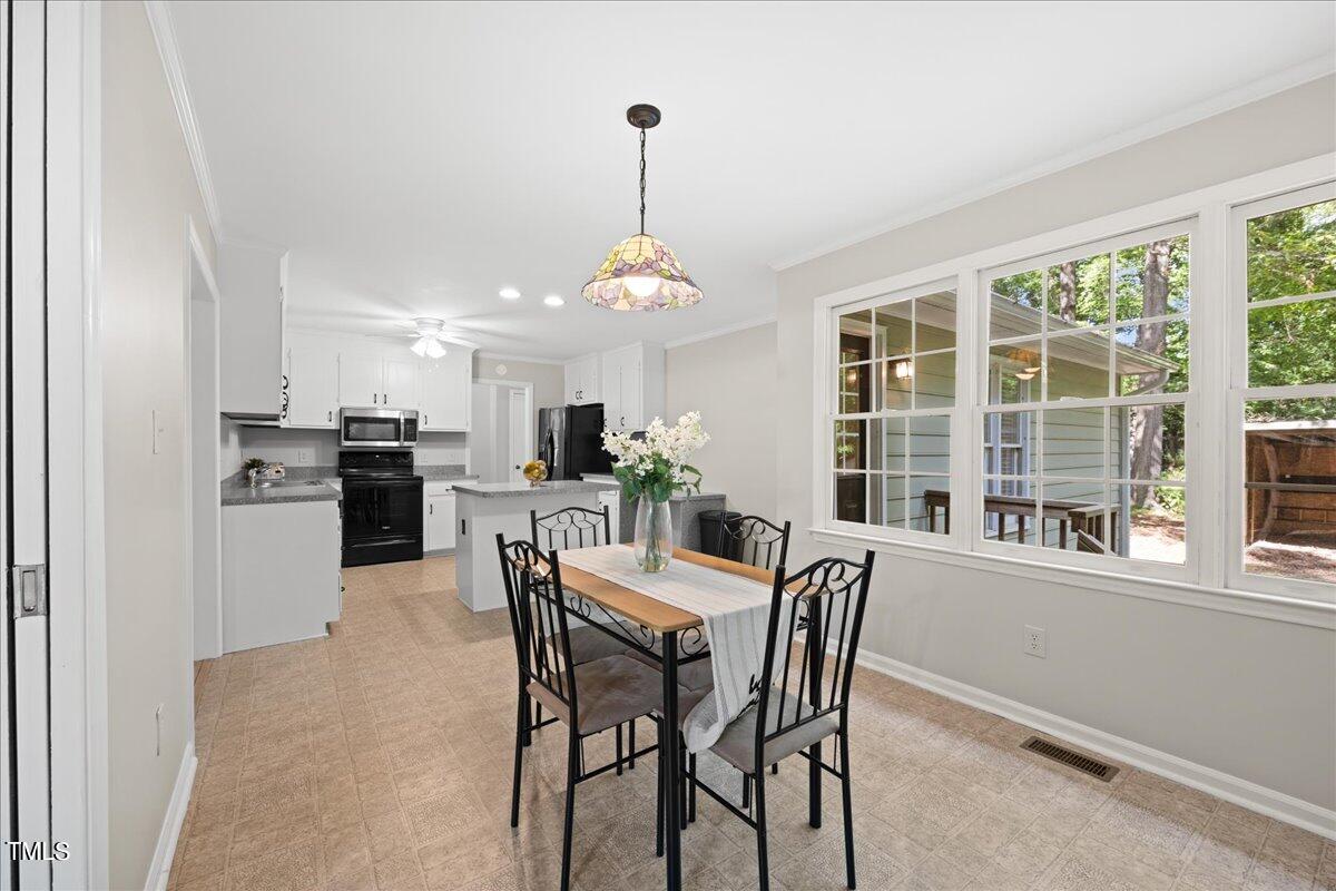 1408 Roy Averette Drive Raleigh, NC 27603 - Photo 11 of 31 a view of a dining room with furniture window and wooden floor