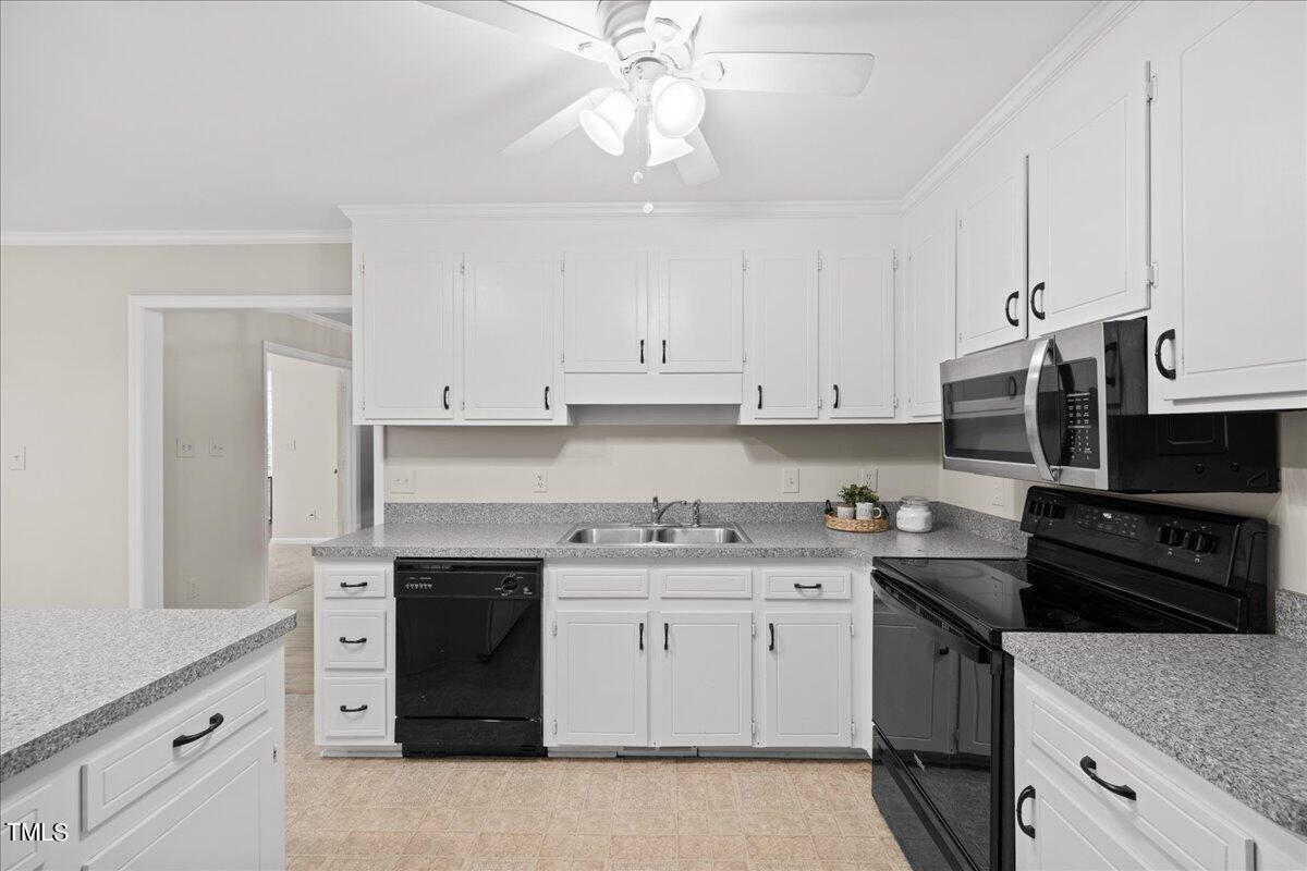 1408 Roy Averette Drive Raleigh, NC 27603 - Photo 13 of 31 a kitchen with a sink stove and cabinets