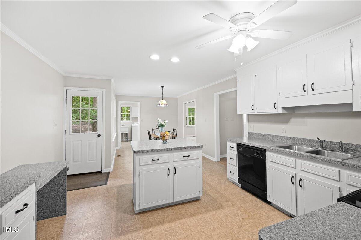 1408 Roy Averette Drive Raleigh, NC 27603 - Photo 14 of 31 a kitchen with a sink dishwasher a stove a refrigerator and cabinets
