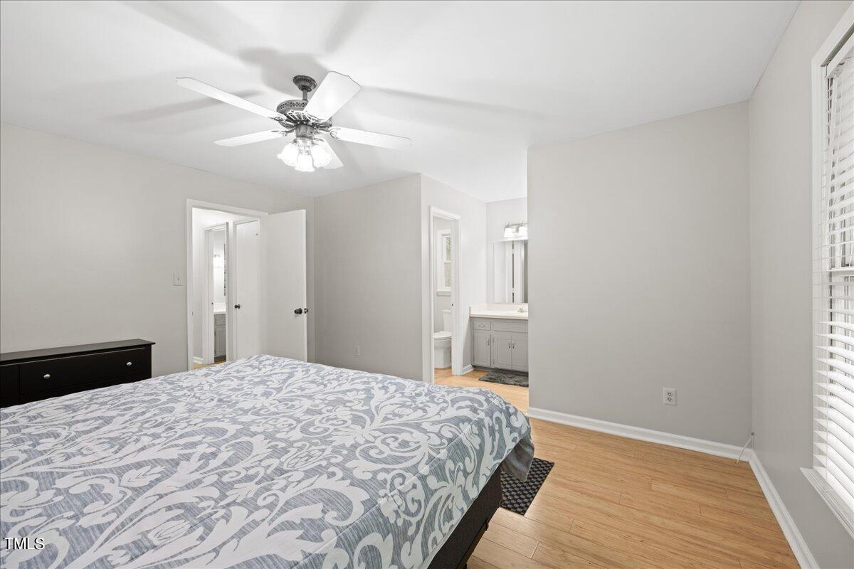1408 Roy Averette Drive Raleigh, NC 27603 - Photo 17 of 31 a bedroom with a bed and a chandelier