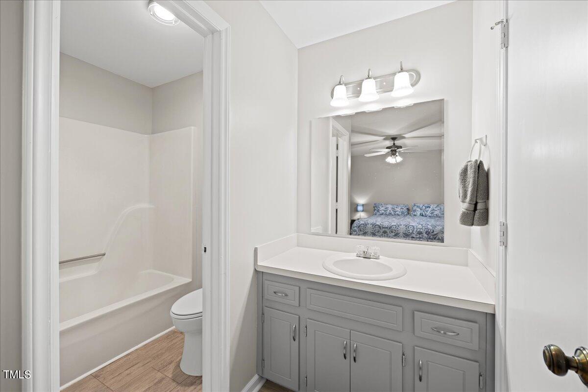 1408 Roy Averette Drive Raleigh, NC 27603 - Photo 18 of 31 a bathroom with a sink a toilet and shower