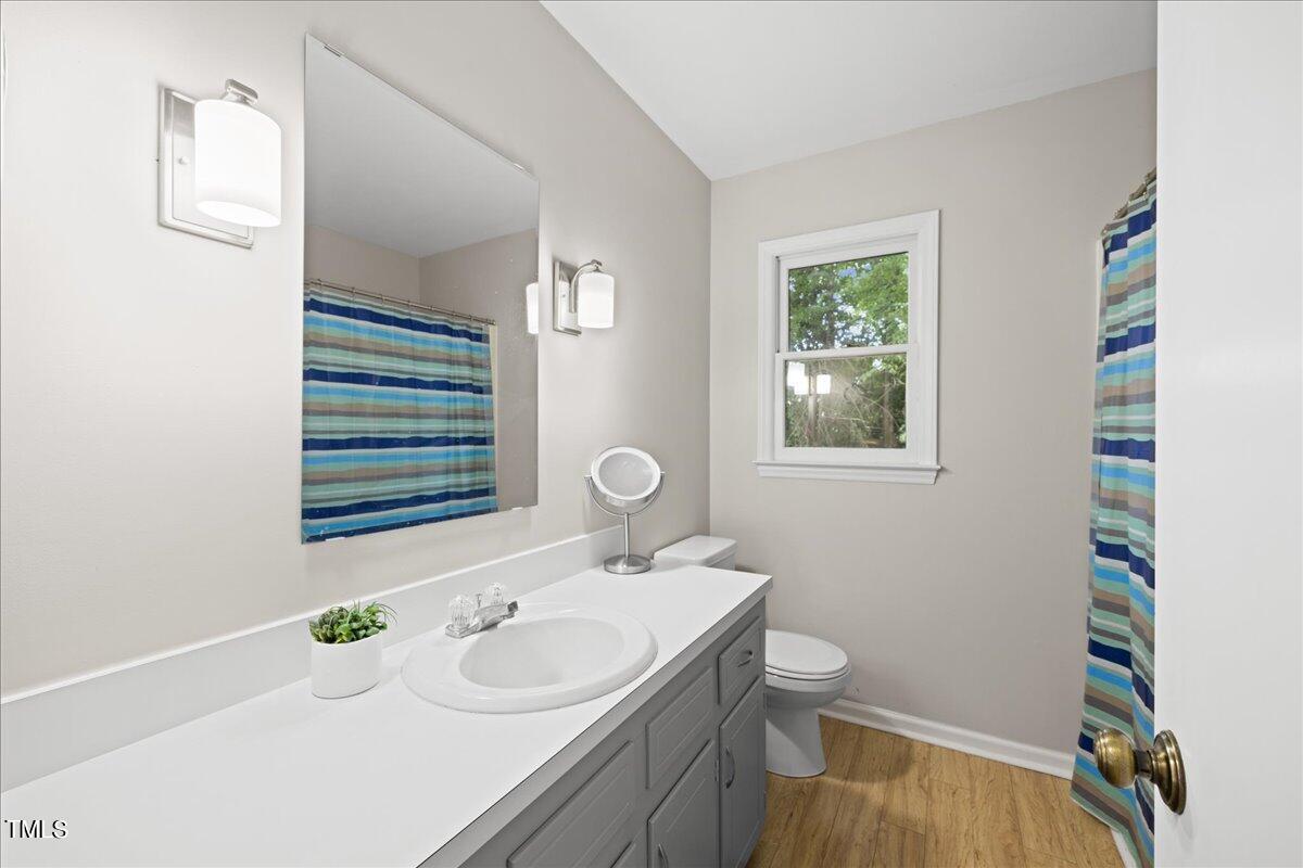 1408 Roy Averette Drive Raleigh, NC 27603 - Photo 20 of 31 a bathroom with a sink and a mirror