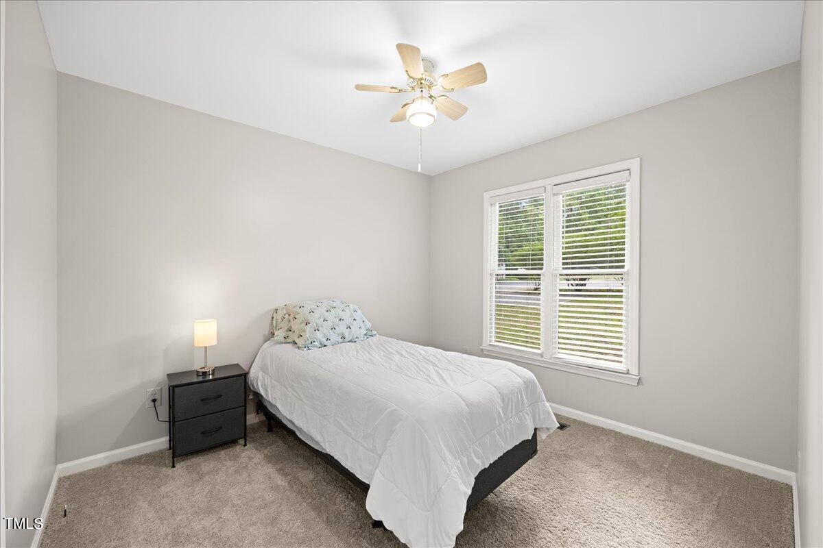 1408 Roy Averette Drive Raleigh, NC 27603 - Photo 21 of 31 a bedroom with a bed and a ceiling fan
