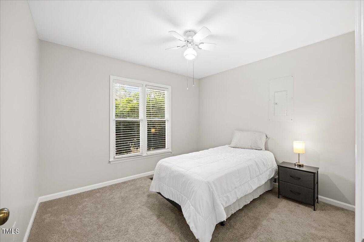 1408 Roy Averette Drive Raleigh, NC 27603 - Photo 22 of 31 a bedroom with a large bed and a ceiling fan