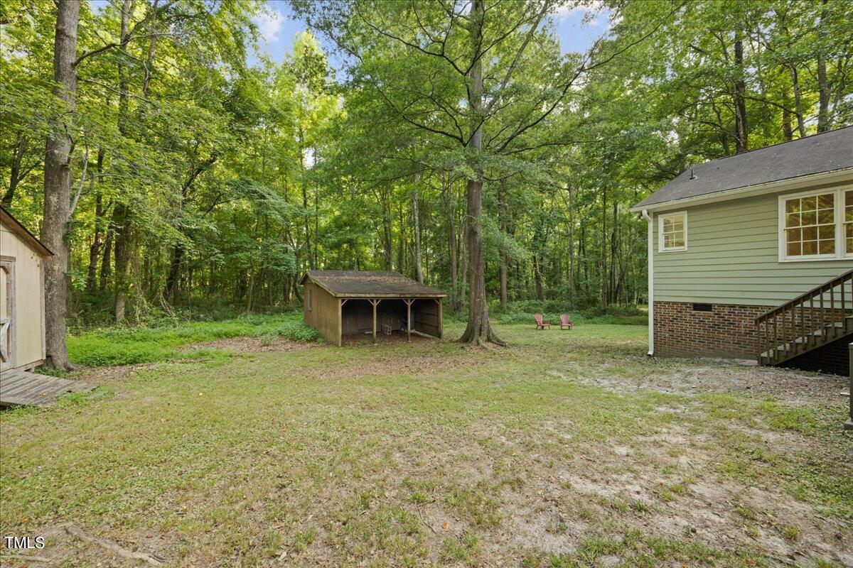 1408 Roy Averette Drive Raleigh, NC 27603 - Photo 25 of 31 a view of a house with backyard and sitting area