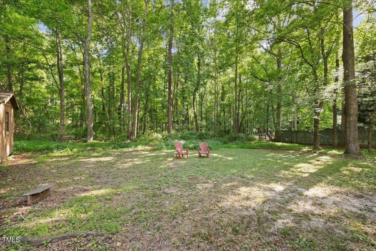 1408 Roy Averette Drive Raleigh, NC 27603 - Photo 26 of 31 a backyard of a house with trampoline