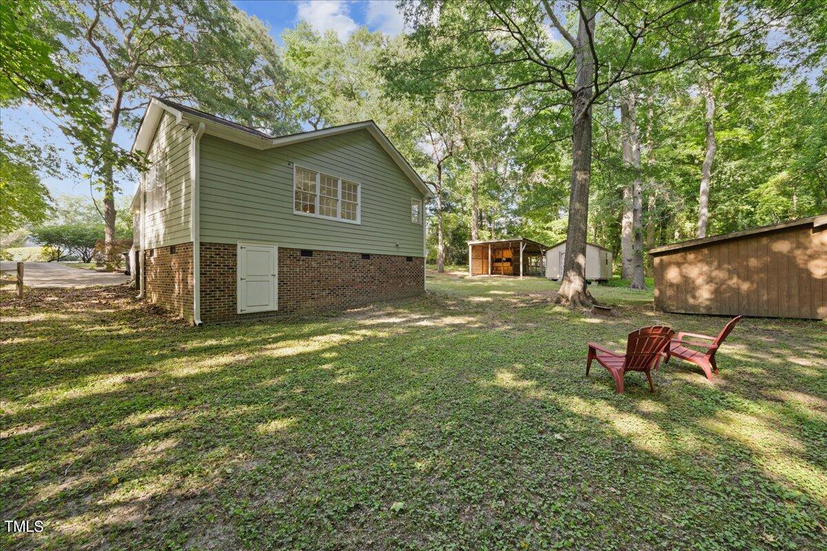 1408 Roy Averette Drive Raleigh, NC 27603 - Photo 27 of 31 a backyard of a house with table and chairs