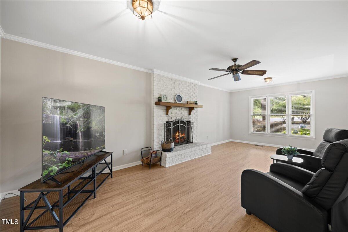 1408 Roy Averette Drive Raleigh, NC 27603 - Photo 7 of 31 a living room with furniture and a fireplace