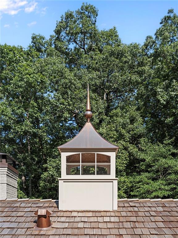 3990 Paces Ferry Road Northwest Atlanta, GA 30327 - Photo 50 of 67 a front view of a house with a yard and garage