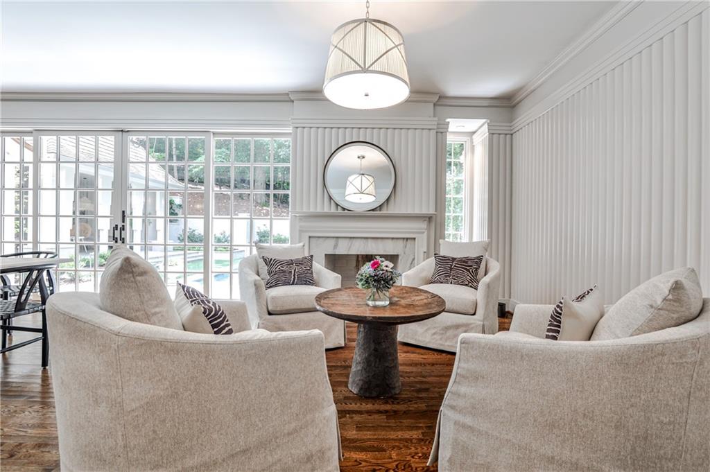 3990 Paces Ferry Road Northwest Atlanta, GA 30327 - Photo 10 of 67 a living room with furniture a fireplace and a large window