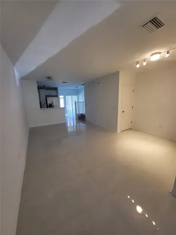 a living room with furniture and a toilet