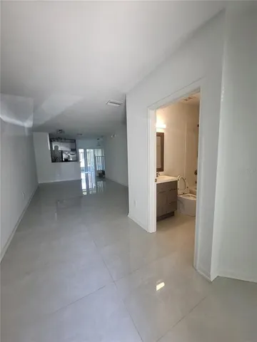 a bedroom with furniture and a large window