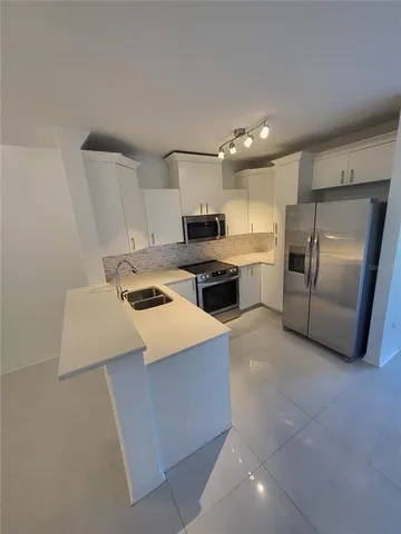 a bathroom with a double vanity sink toilet mirror and bathtub