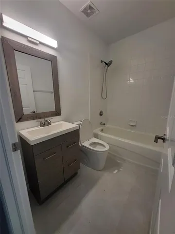 a bathroom with a sink a toilet and bathtub
