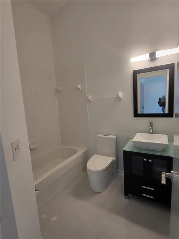 en empty room with windows and fan