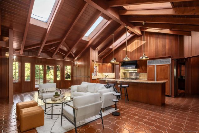 a dining room with furniture a fireplace and chandelier
