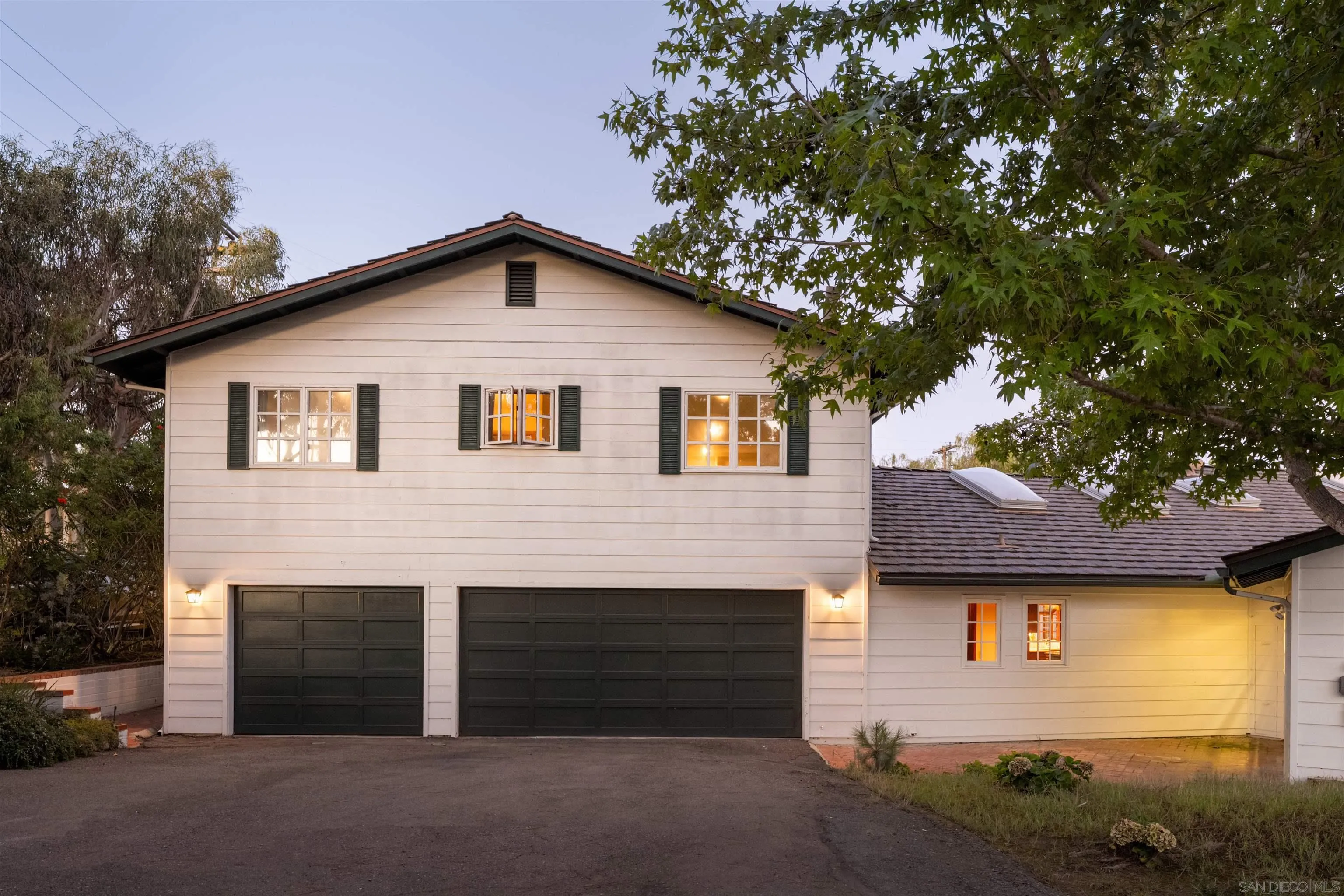 1654 La Jolla Rancho Road La Jolla, CA 92037 - Photo 24 of 31 a front view of a house with a yard and garage