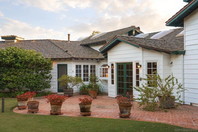 an aerial view of a house with a yard and a fountain