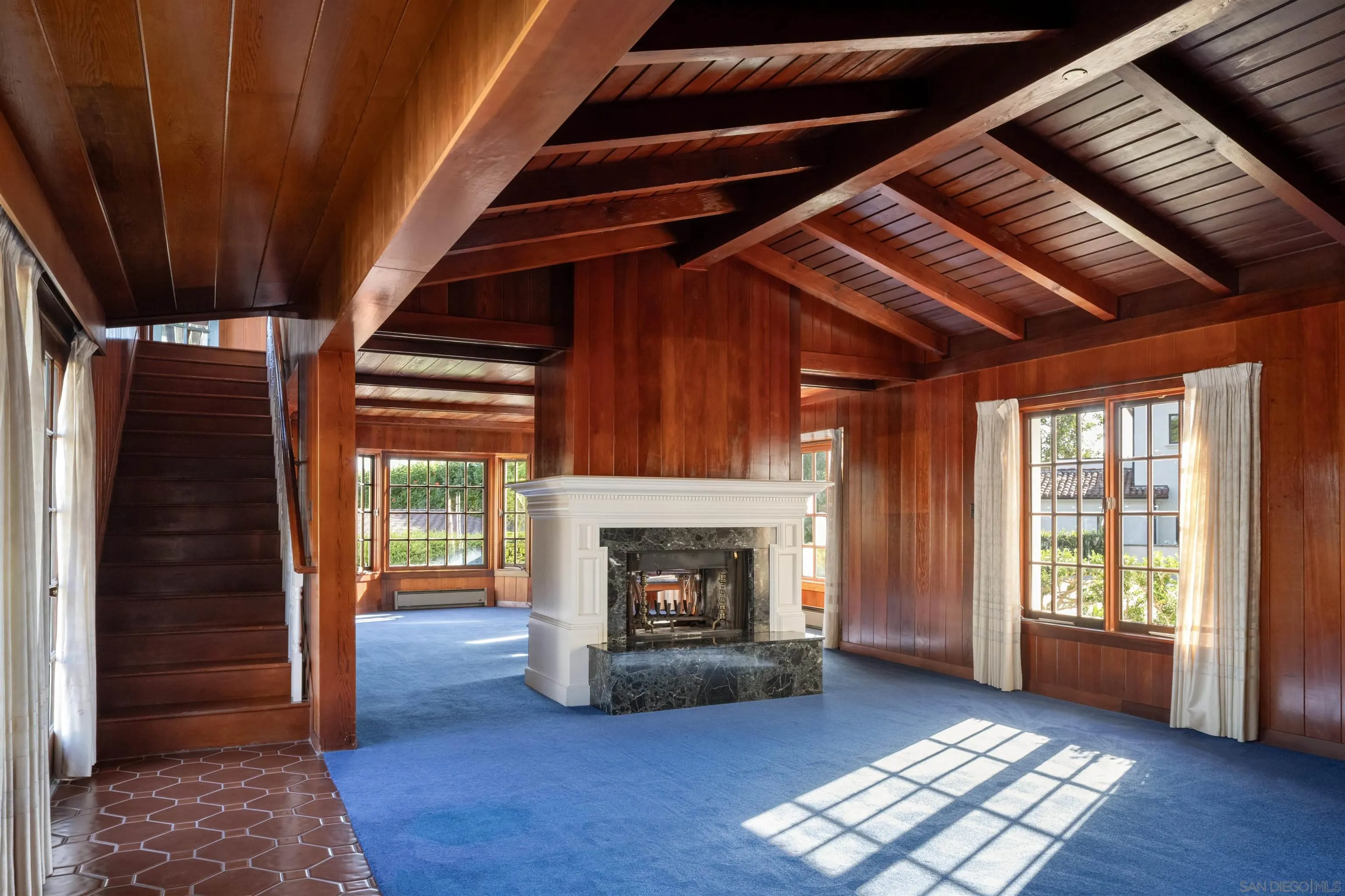 1654 La Jolla Rancho Road La Jolla, CA 92037 - Photo 8 of 31 a view of an empty room with wooden floor fireplace and a window