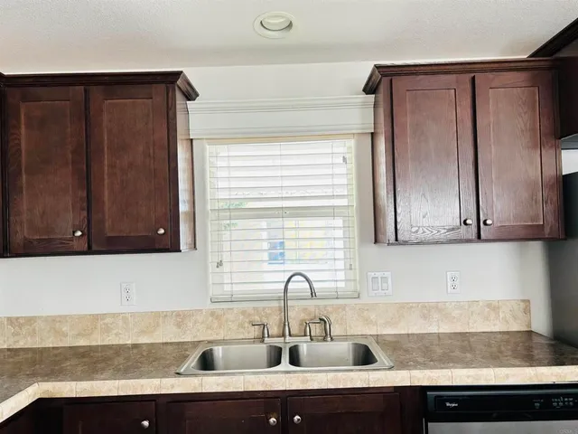 a kitchen with a sink and cabinets